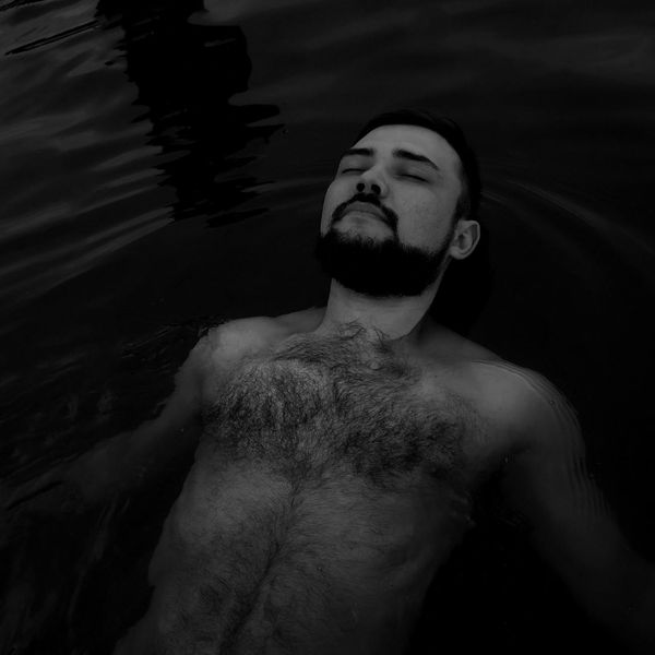 Person meditating peacefully in a bright, minimalist room.